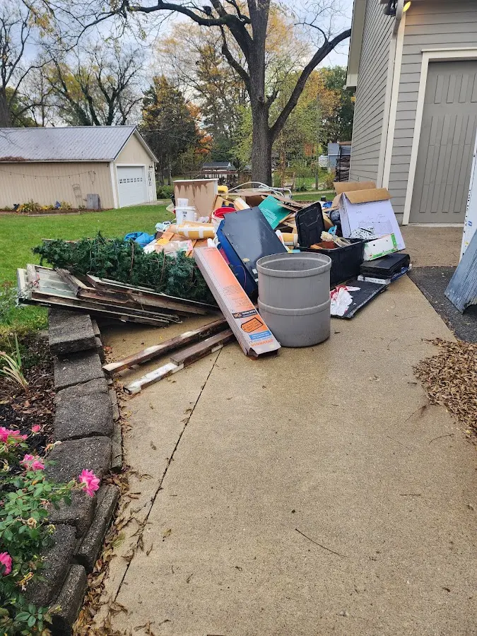 Dumpster being loaded with debris for Estate Cleanout Dumpster Rental in Patchogue